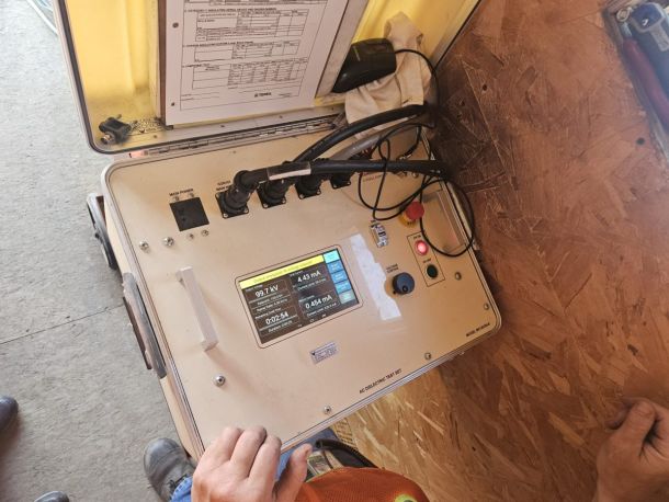 Qualification testing can only be done with an AC testing machine. The test is conducted by qualified service personnel anytime the fiberglass boom section is modified or replaced. A written record of all dielectric tests should be maintained, including both the date and the signature of the person who performed the test.